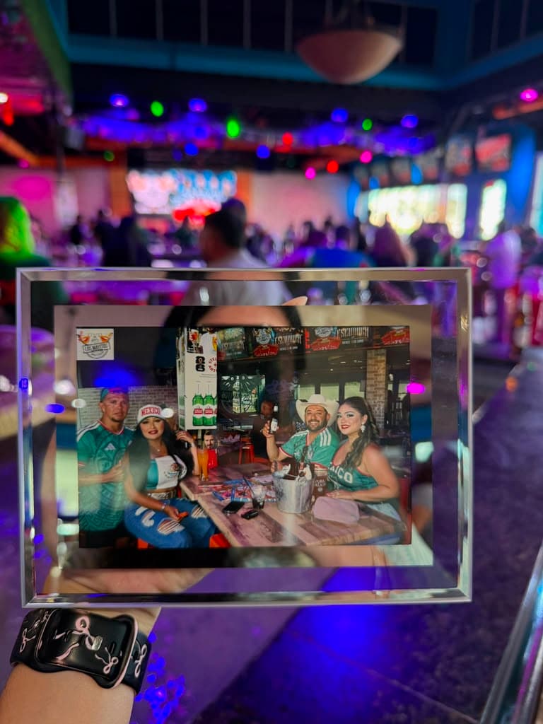 Fans holding LuminaR frame at sports bar